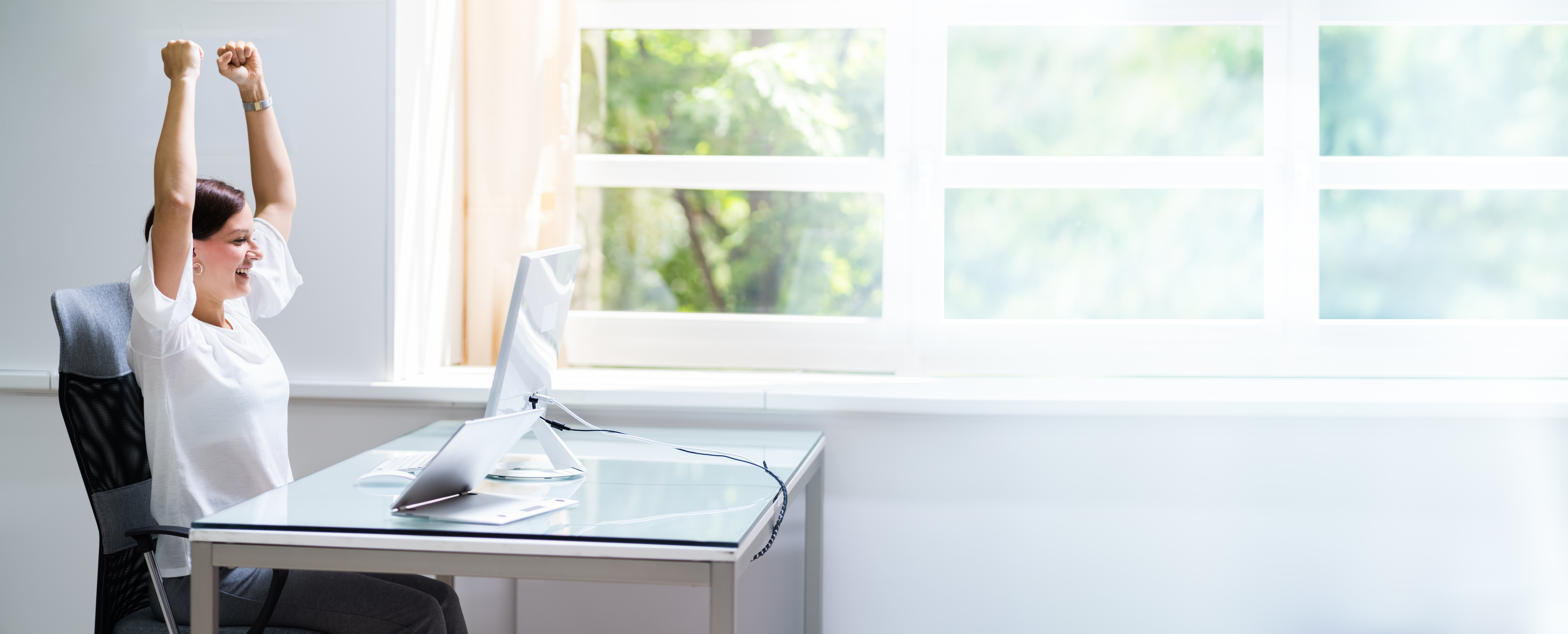 Happy Woman At Computer With Hands Raised